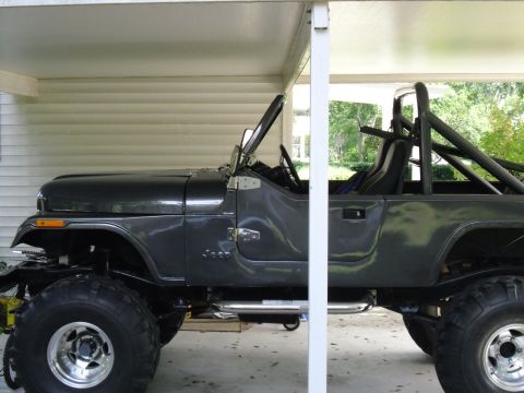 1978 Ford Bronco - This Jeep CJ-7 features a roll cage and oversized tires, suggesting it is modified for off-road use.