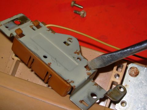 1983 Ford Bronco - Release the catch and slide the plastic housing off the metal plate. To make reassembly easier, trim the peg that was cut off so it does NO…