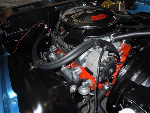 1972 Chevrolet Camaro - The engine bay of a 1972 Chevrolet Camaro features a chrome air cleaner and an orange-painted engine block.