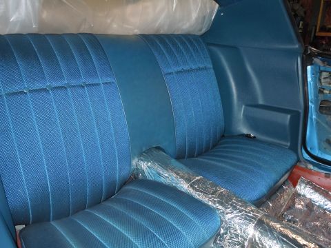 1972 Chevrolet Camaro - Rear interior of a 1972 Chevrolet Camaro, showing blue seats and some protective plastic.