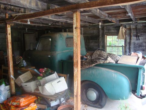 2002 Chevrolet Silverado 1500 - This vintage pickup truck, likely from the late 1940s to mid-1950s, is stored in a cluttered barn.