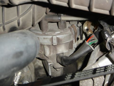 1996 Ford Bronco - Close-up view of an engine's distributor cap and associated wiring.