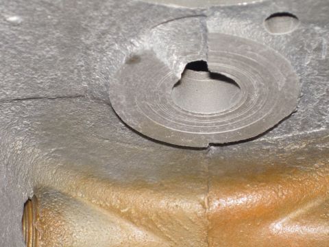 1979 Ford Bronco - Detail of a metal part, possibly from an engine or transmission, showing wear and casting marks.