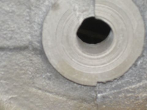 1979 Ford Bronco - A close-up view of a metal component, possibly from a vehicle, with a central opening and concentric markings.