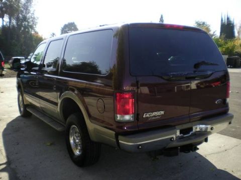 2000 Ford Excursion - Rear view of a dark red 2000 Ford Excursion, tinted windows and a chrome bumper.
