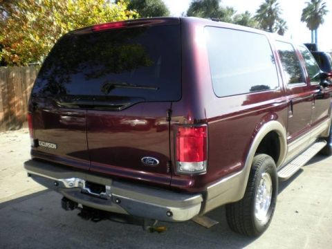 2000 Ford Excursion - Rear view of a maroon Ford Excursion SUV parked outdoors.