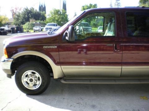 2000 Ford Excursion - Side view of a maroon Ford Excursion SUV, showing its two-tone paint and running boards.