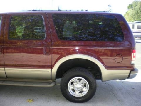 2000 Ford Excursion - The side profile of a maroon Ford Excursion SUV is shown, tan two-tone paint and running boards.