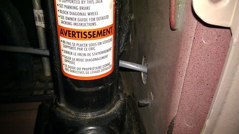 2000 Ford Excursion - Driver side wire run down the brake light housing area, through a rectangular floor support tube then back up forward of the passenger side…