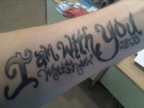 1989 Ford Bronco - A tattoo displays a Bible verse on a person's arm.