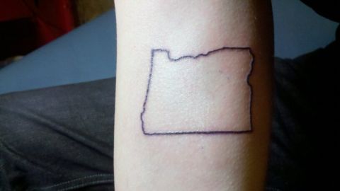 1989 Ford Bronco - A tattoo of the state of Oregon is visible on a person's arm.