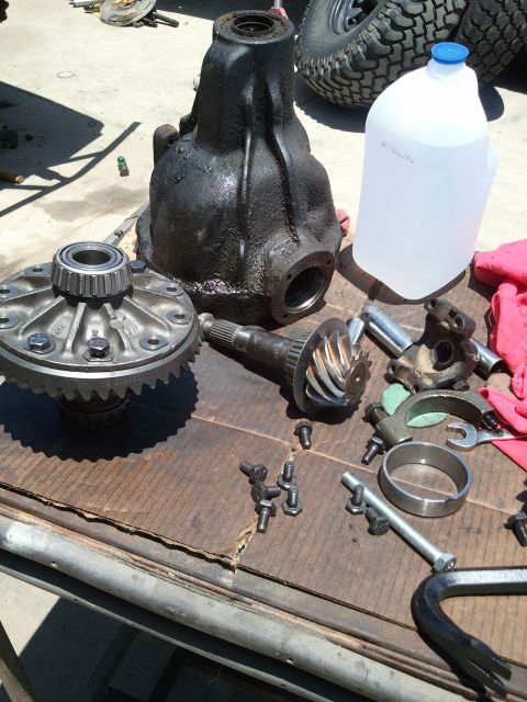 1982 Ford Bronco - Differential components and tools are spread out on a workbench, ready for installation or repair.
