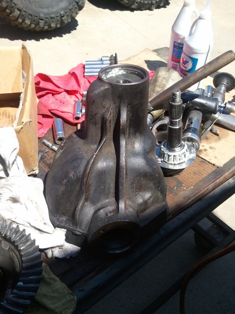 1982 Ford Bronco - Differential housing and gears are laid out on a table with various tools and bottles, suggesting a repair or installation process.