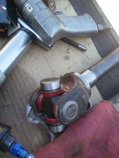 1982 Ford Bronco - Tools and a universal joint are laid out, suggesting a repair or installation process.