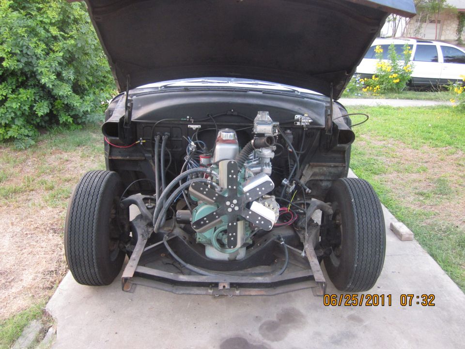 Car with hood up showing engine and front suspension. Date stamp reads 06/25/2011