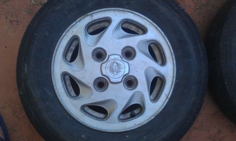 1991 Ford Festiva - A close-up view of a single silver alloy wheel with a visible Ford emblem.