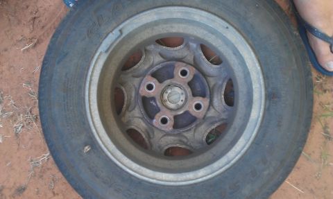 1991 Ford Festiva - A single wheel and tire assembly is shown, likely removed from a vehicle.
