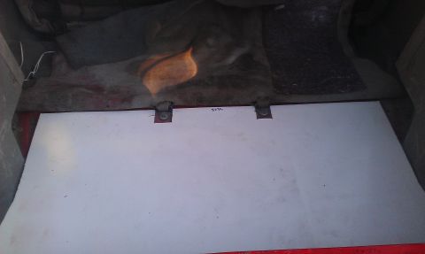 1991 Ford Festiva - The interior cargo area of a vehicle shows a white panel with some handwritten text. The registry information may be incorrect.