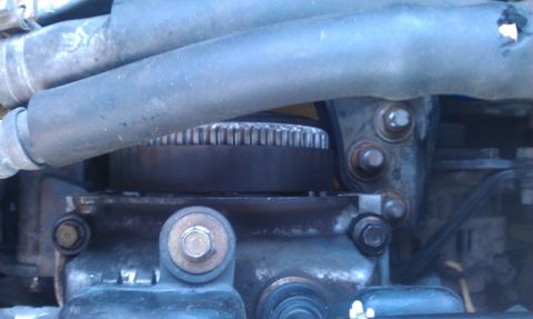 1991 Ford Festiva - Engine part detail showing a toothed pulley and associated hardware.