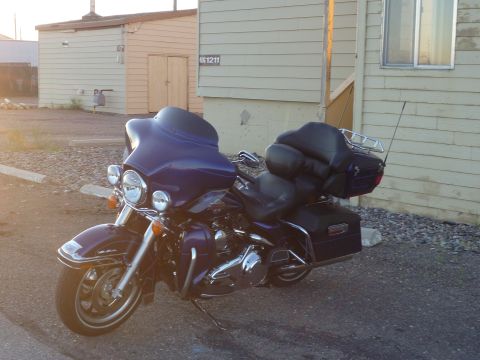 2007 Harley-Davidson Electra Glide Clsc - A purple 2007 Harley-Davidson Electra Glide Clsc is parked in front of a beige building during the day.