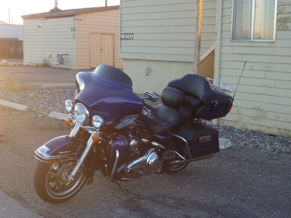 Purple Harley-Davidson Electra Glide Clsc parked outside a building