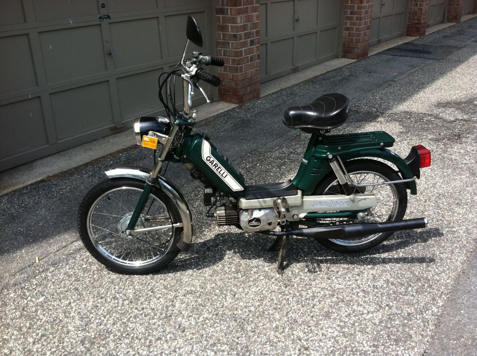 Green Garelli moped with white stripe on the side