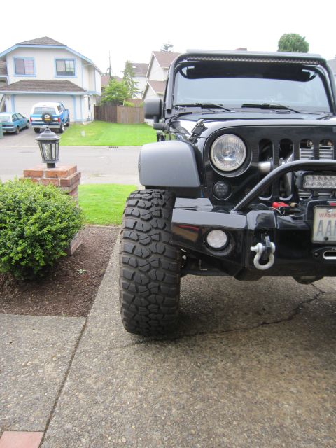 2008 Jeep Wrangler - This black Jeep Wrangler features aftermarket fenders and aggressive off-road tires, suggesting modifications beyond its original factory s…
