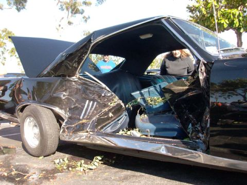 2007 Ford Mustang - The interior of a classic car shows extensive damage after an accident, with debris scattered throughout the cabin.