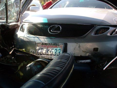 2007 Ford Mustang - Front view of a damaged silver Lexus sedan with its grille and license plate visible.