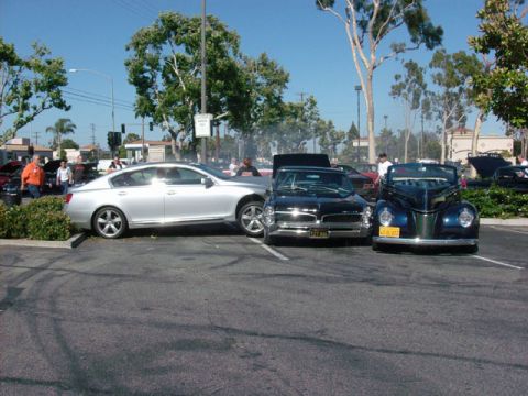 2007 Ford Mustang - Multiple vehicles are parked in an outdoor lot on a sunny day.