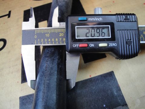 2003 Ford Taurus - Digital caliper measures a part at 20.96 mm.