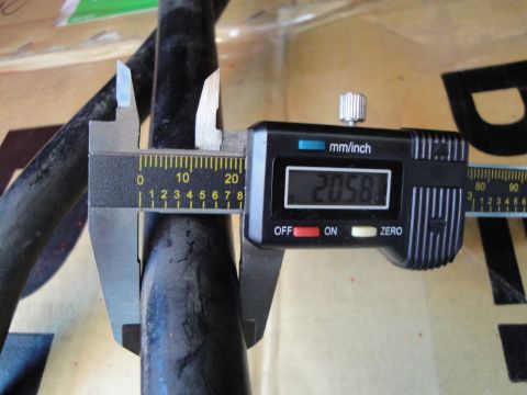 2003 Ford Taurus - A digital caliper is used to measure the diameter of a black cylindrical object.