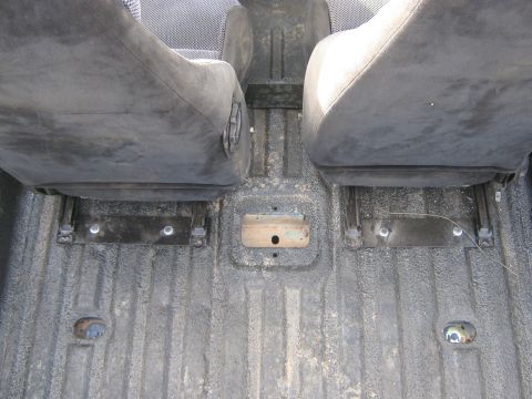 1978 Ford Bronco - Close-up of the interior floor and front seats of a vehicle.