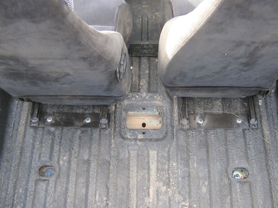Interior view of front seats and textured floor