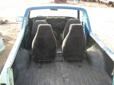 1978 Ford Bronco - Interior of a blue pickup truck showing four seats and the dashboard area.