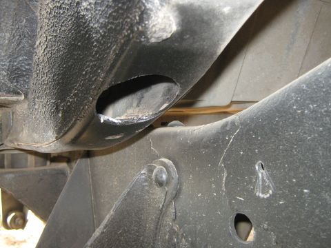 1978 Ford Bronco - Damage to the vehicle frame is visible, with a hole cut into the metal structure.