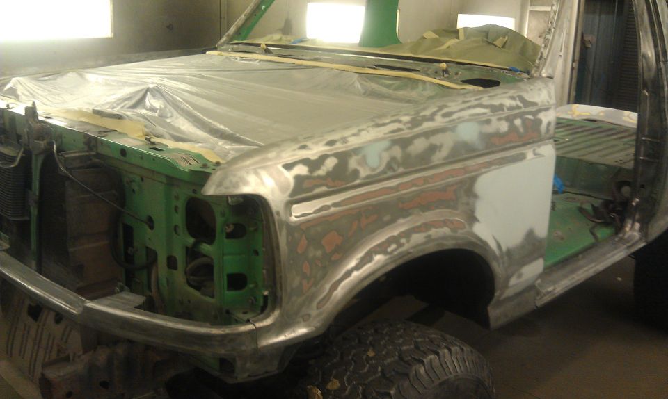 1995 Ford Bronco front fender and hood undergoing bodywork