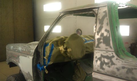 1995 Ford Bronco - Ford Bronco undergoing bodywork and preparation for paint in a booth.