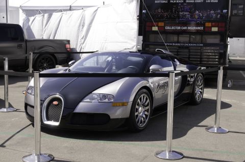 2006 Cadillac STS - A Bugatti Veyron is displayed at an event, with a truck visible in the background.