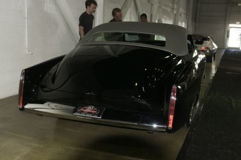 2006 Cadillac STS - Rear view of a black convertible with a grey top, a license plate celebrating a 40th anniversary.
