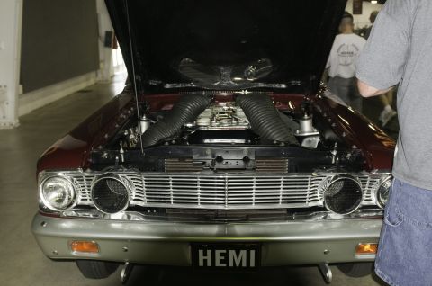 2006 Cadillac STS - The engine bay of a classic car is displayed with the hood up, prominent air intake tubes and a HEMI designation.