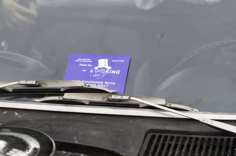 2006 Cadillac STS - A purple card is placed on the windshield, partially obscured by wiper blades.