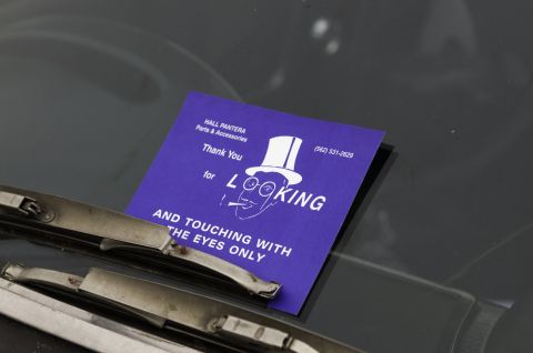 2006 Cadillac STS - Card on windshield says 'AND TOUCHING WITH THE EYES ONLY'.