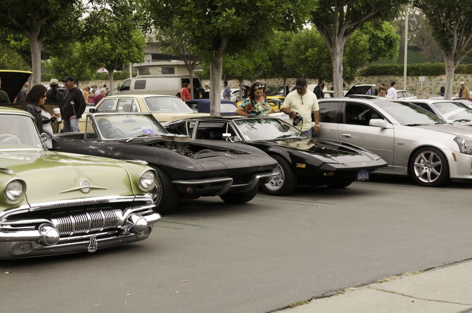 Car show row: 1950s Pontiac, black C2 Corvette, black Pantera and silver Cadillac CTS-V