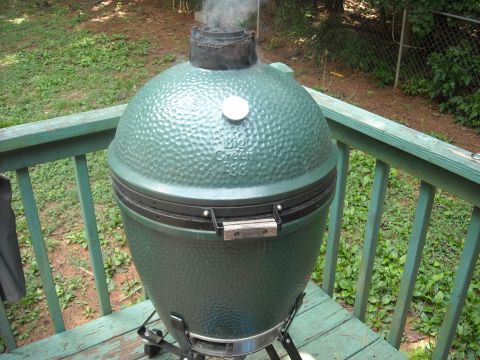 1979 Ford F-150 - A Big Green Egg grill is smoking on a weathered green wooden deck.