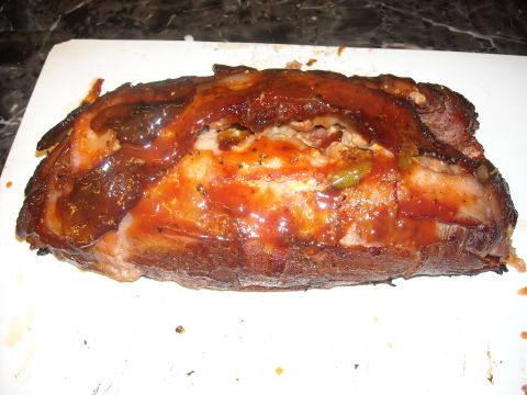 1979 Ford F-150 - A close-up view of a cooked meatloaf, glazed with barbecue sauce and wrapped in bacon.
