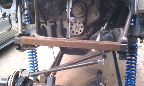 1990 Ford Bronco - Close-up view of a vehicle's engine bay and suspension modifications, with visible text from SuperMotors.net.