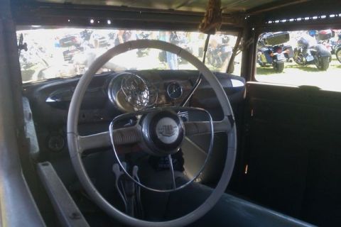1991 Ford LTD Crown Victoria - View from inside a vintage car, looking out at motorcycles parked on a sunny day.