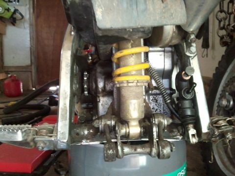 1985 Ford F-150 - Close-up view of a motorcycle's rear suspension system, showing the shock absorber and linkage components.