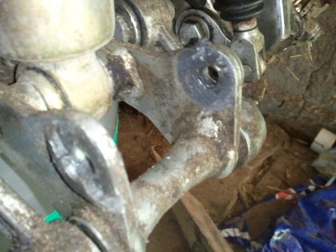 1985 Ford F-150 - This image shows a close-up of a heavily corroded vehicle suspension part, likely from a truck or SUV.